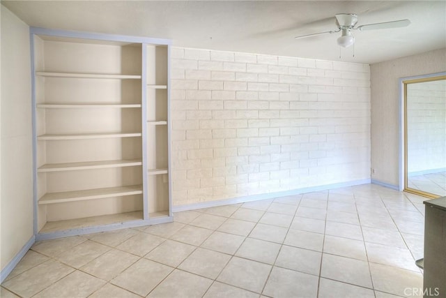 spare room featuring ceiling fan, baseboards, and light tile patterned flooring