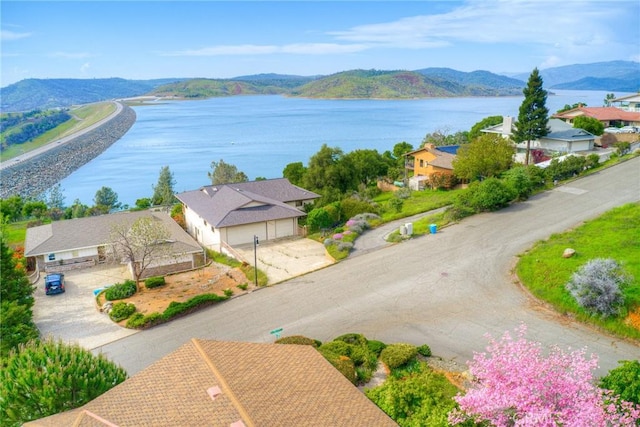 drone / aerial view with a water and mountain view