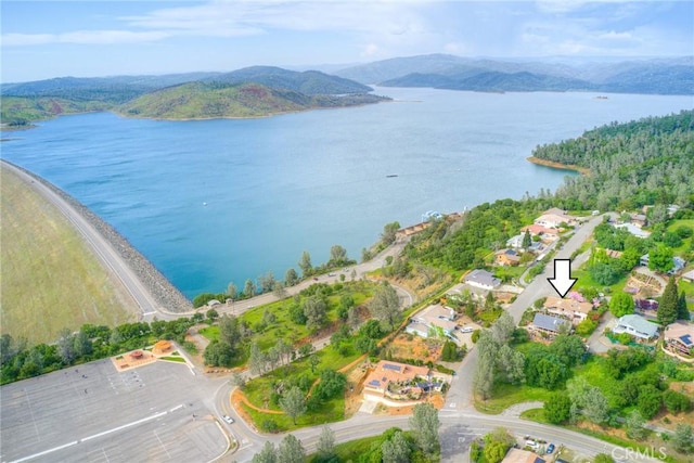 drone / aerial view featuring a water and mountain view