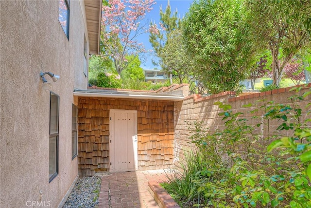 exterior space with fence and stucco siding