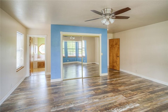 interior space with ceiling fan, baseboards, and wood finished floors