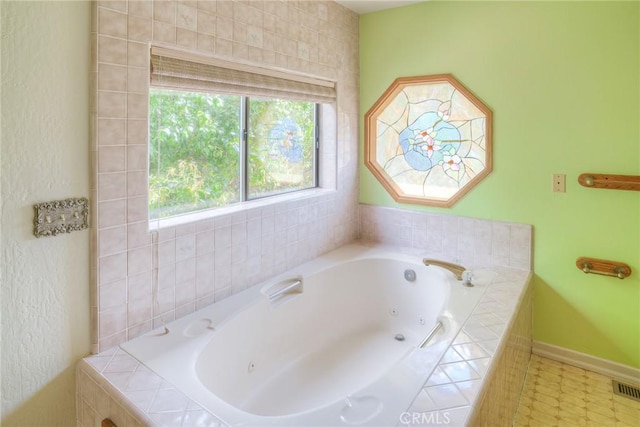bathroom featuring baseboards and a whirlpool tub