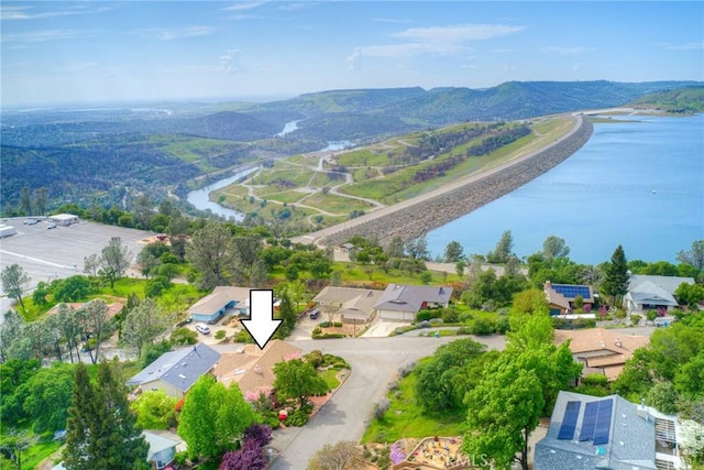 drone / aerial view featuring a water and mountain view