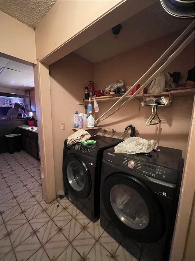 laundry room with laundry area and washing machine and clothes dryer