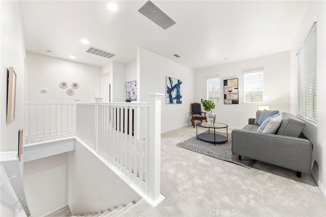 carpeted living room featuring visible vents and recessed lighting