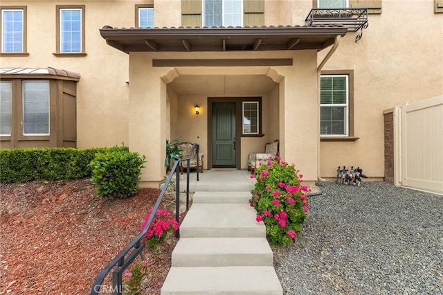 property entrance with stucco siding