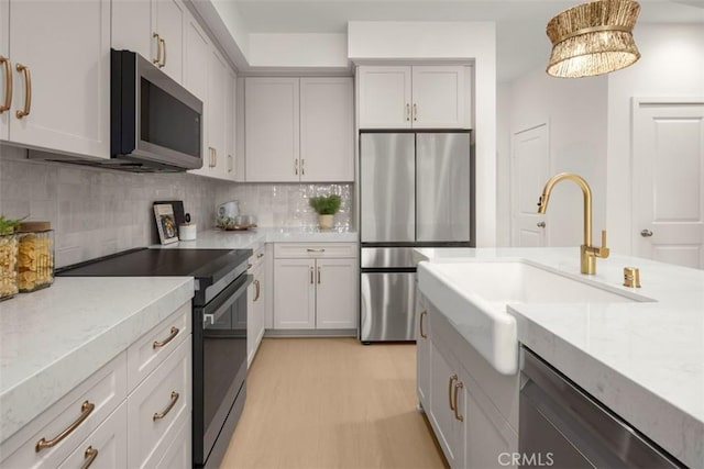 152 Balsawood, Tustin, CA 92780 - kitchen featuring light countertops, a sink, backsplash, and appliances with stainless steel finishes