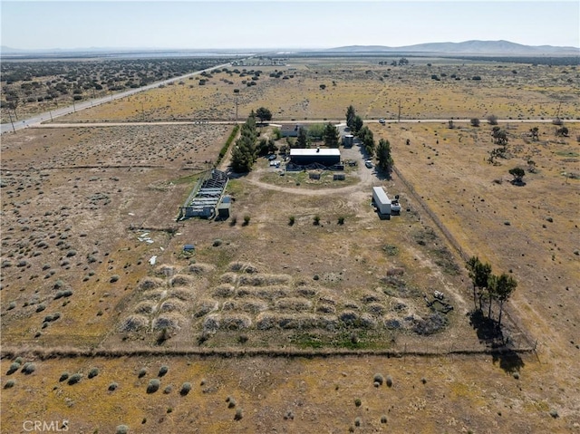 aerial view with a mountain view, a desert view, and a rural view
