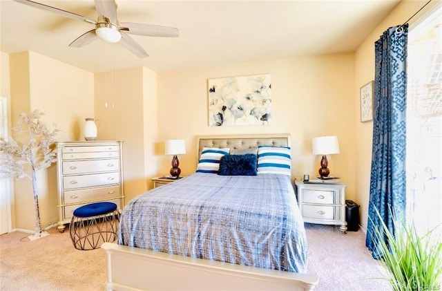 carpeted bedroom with a ceiling fan and baseboards