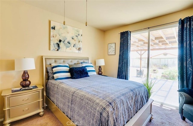 carpeted bedroom with access to exterior