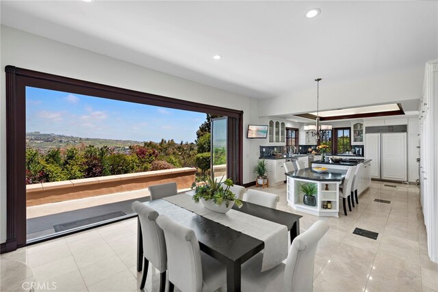 6 Riverstone, Laguna Niguel, CA 92677 - dining room with light tile patterned floors, an inviting chandelier, a healthy amount of sunlight, and recessed lighting