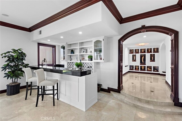 6 Riverstone, Laguna Niguel, CA 92677 - bar featuring visible vents, baseboards, arched walkways, and crown molding
