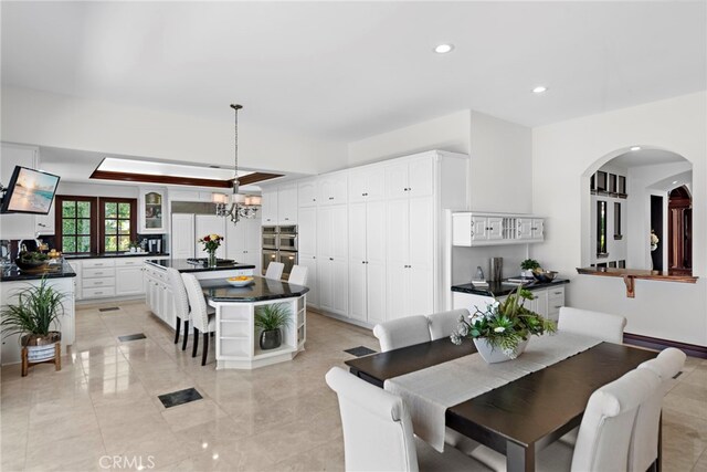 6 Riverstone, Laguna Niguel, CA 92677 - dining area with recessed lighting, arched walkways, a baseboard radiator, and a notable chandelier