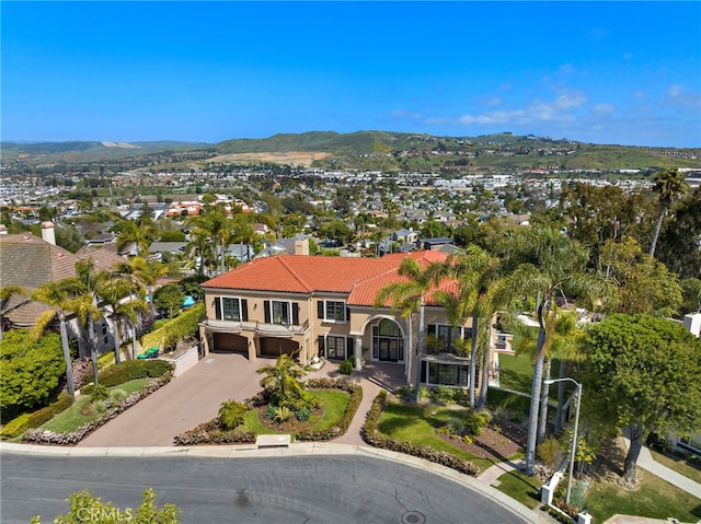 6 Riverstone, Laguna Niguel, CA 92677 - view of front of house with a tile roof, a chimney, driveway, an attached garage, and a mountain view