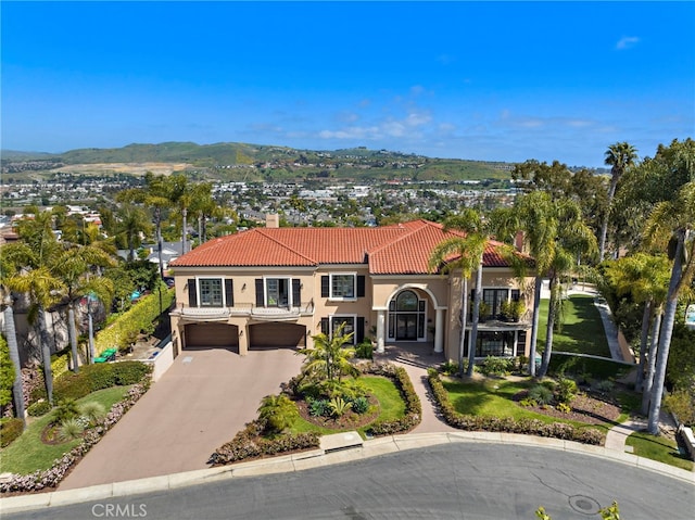 6 Riverstone, Laguna Niguel, CA 92677 - mediterranean / spanish house with a chimney, driveway, a tiled roof, an attached garage, and stucco siding