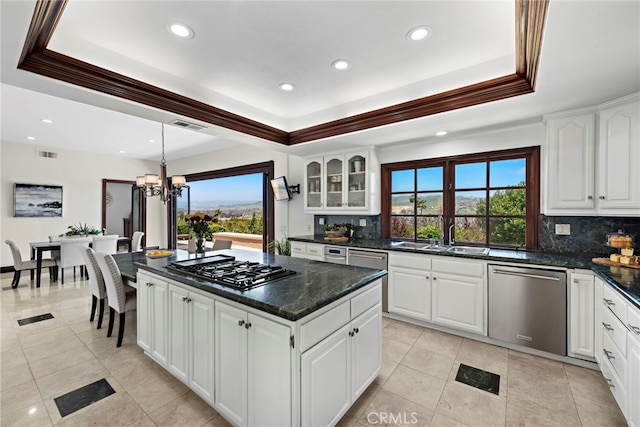 6 Riverstone, Laguna Niguel, CA 92677 - kitchen featuring decorative backsplash, dishwasher, a tray ceiling, and a sink