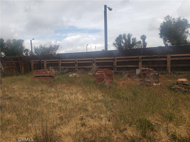 rear view of house featuring fence