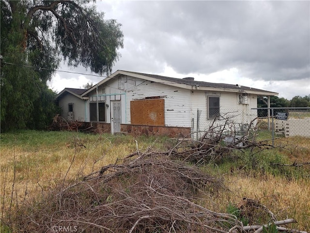 view of side of property featuring fence