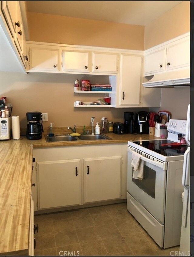1800 E Heim Ave Unit 22, Orange, CA 92865 - kitchen featuring white cabinetry, a sink, under cabinet range hood, white electric range, and tile patterned floors