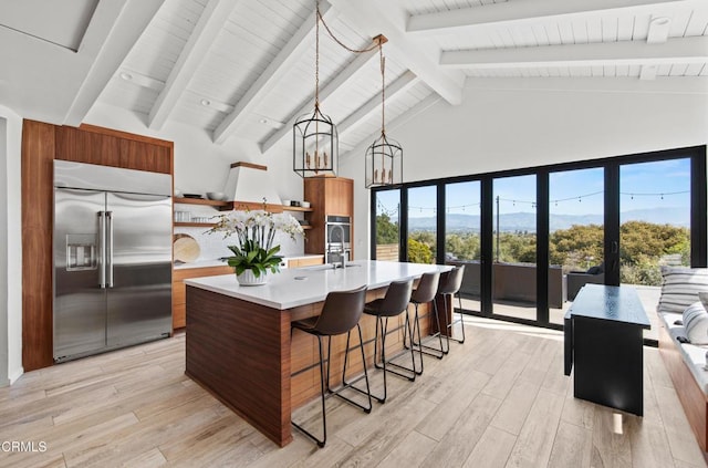 1270 Dove Meadow Rd, Solvang, CA 93463 - kitchen featuring built in refrigerator, light countertops, modern cabinets, high vaulted ceiling, and light wood-style floors