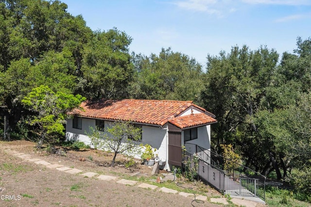 1270 Dove Meadow Rd, Solvang, CA 93463 - mediterranean / spanish-style house with a tile roof, stucco siding, and stairway