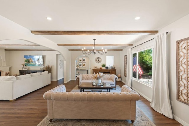 living room with dark wood finished floors, recessed lighting, arched walkways, and an inviting chandelier