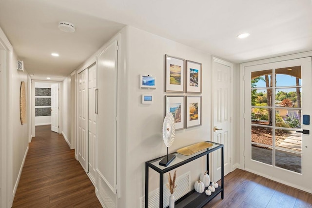 hall with dark wood finished floors, baseboards, and recessed lighting