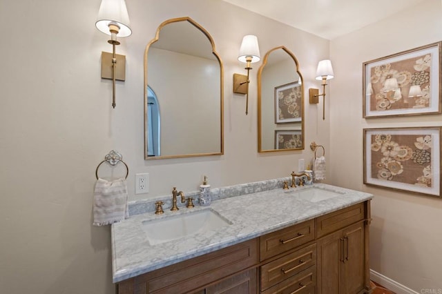 full bathroom with double vanity and a sink