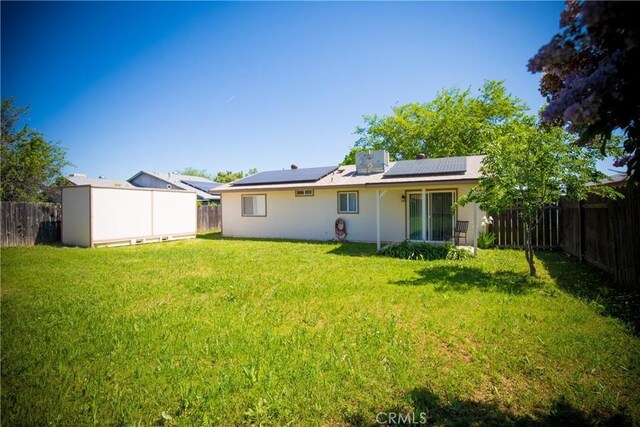 272 Rio Bravo Ct, Corning, CA 96021 - rear view of property featuring stucco siding, a fenced backyard, a yard, and solar panels