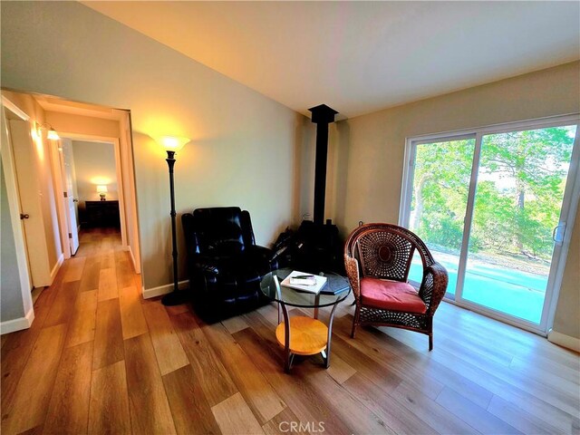 47180 Lookout Mountain Dr, Coarsegold, CA 93614 - living area featuring wood finished floors, baseboards, and a wood stove