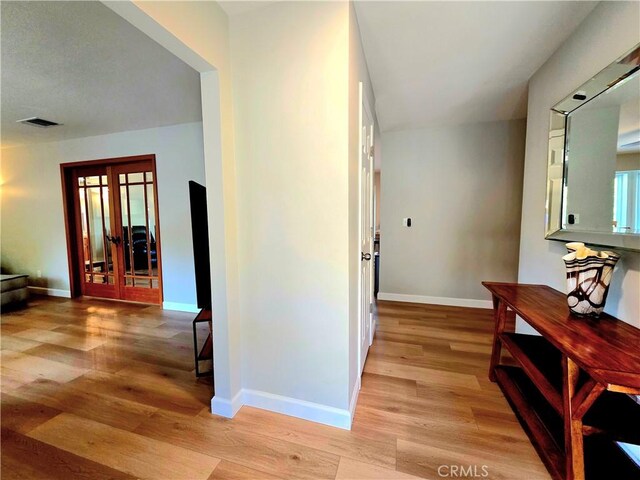 47180 Lookout Mountain Dr, Coarsegold, CA 93614 - hall with light wood-style flooring, baseboards, and french doors