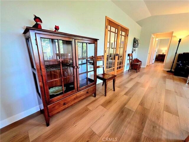 47180 Lookout Mountain Dr, Coarsegold, CA 93614 - corridor featuring french doors, wood finished floors, lofted ceiling, and baseboards