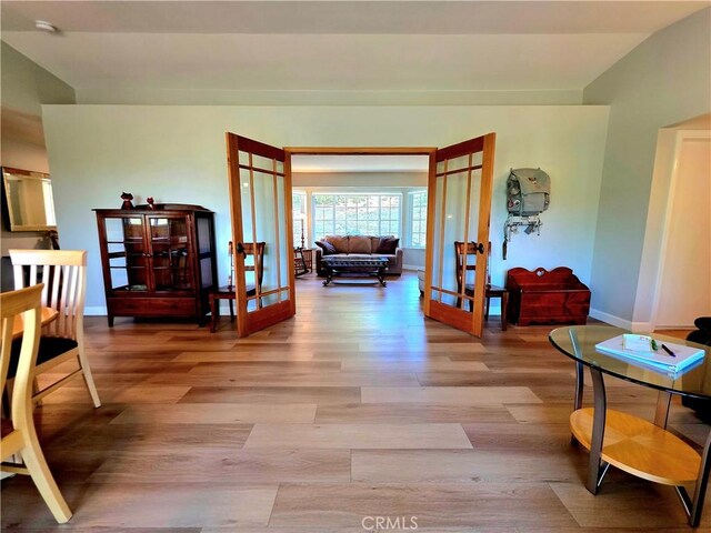47180 Lookout Mountain Dr, Coarsegold, CA 93614 - corridor with french doors, wood finished floors, baseboards, and lofted ceiling