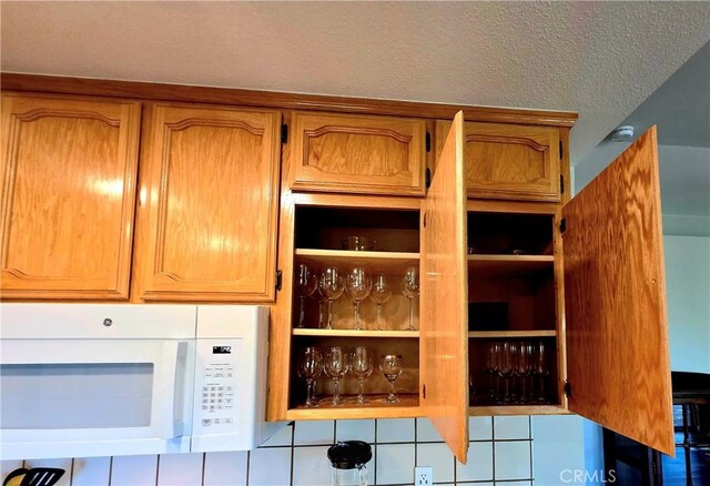 47180 Lookout Mountain Dr, Coarsegold, CA 93614 - kitchen view of white microwave, brown cabinets, and a textured ceiling