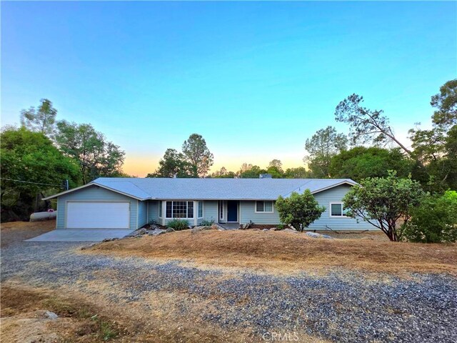 47180 Lookout Mountain Dr, Coarsegold, CA 93614 - ranch-style home with an attached garage, gravel driveway, and a chimney