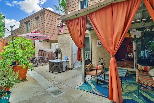 view of patio with central air condition unit and outdoor dining area