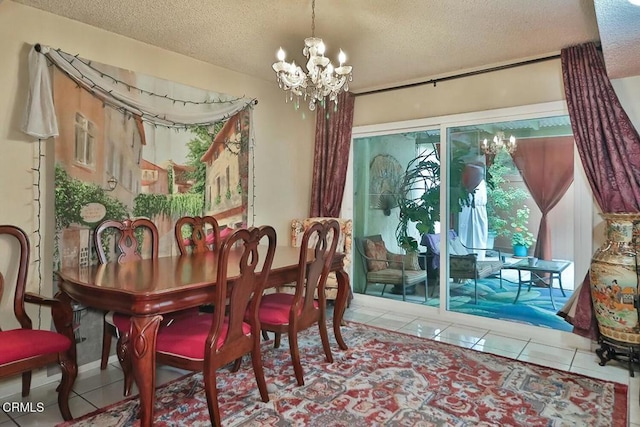 dining space with a chandelier, a textured ceiling, and tile patterned floors