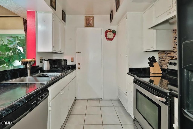 kitchen with appliances with stainless steel finishes, a sink, white cabinets, light tile patterned floors, and under cabinet range hood