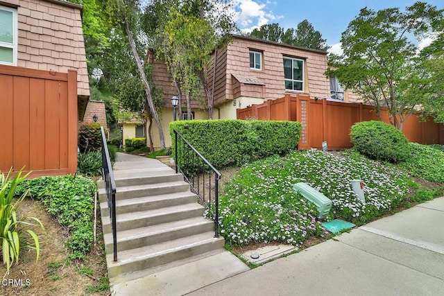 view of yard with fence and stairs