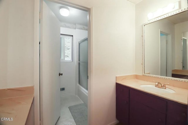 bathroom featuring vanity and combined bath / shower with glass door