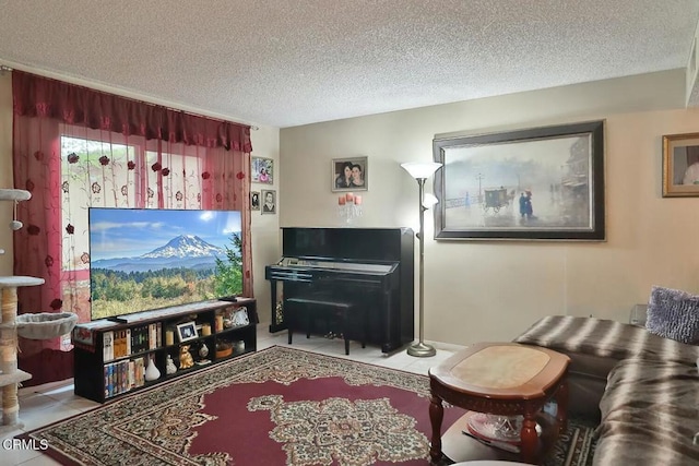 sitting room featuring a textured ceiling and tile patterned flooring