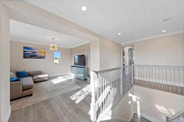 living room with baseboards, ornamental molding, and recessed lighting