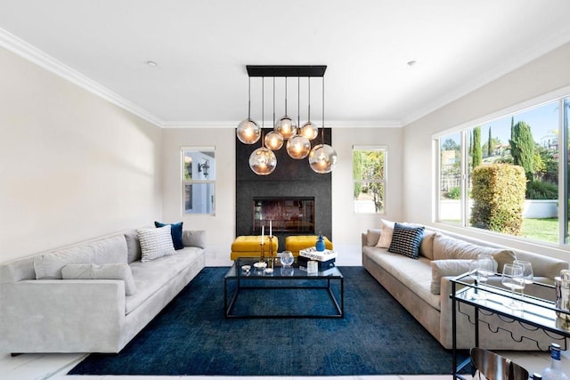 living area featuring a fireplace, ornamental molding, and an inviting chandelier