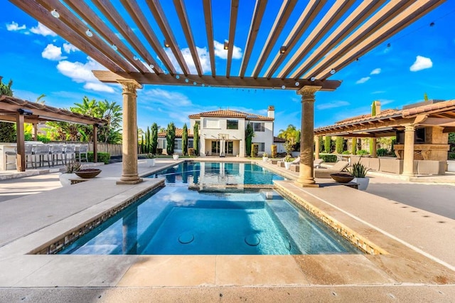 pool with a pergola, an outdoor bar, a patio area, and an in ground hot tub
