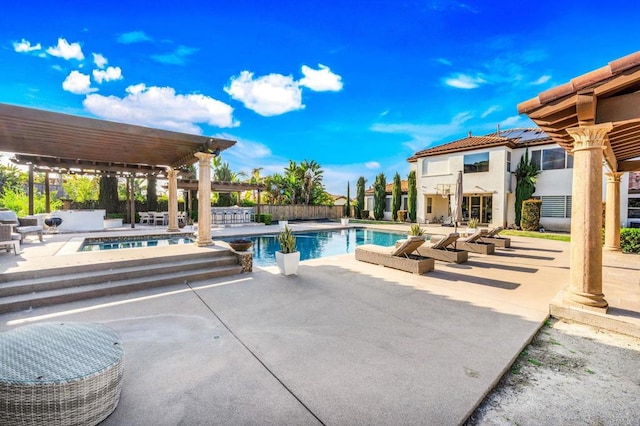 view of pool featuring a patio, a fenced in pool, and an in ground hot tub
