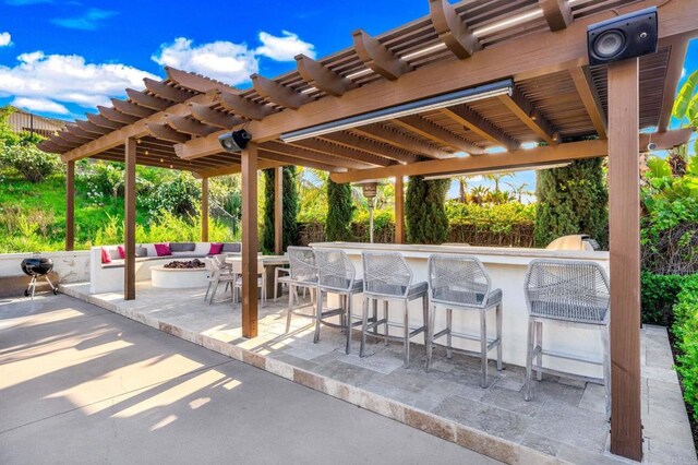 view of patio / terrace featuring a pergola, an outdoor fire pit, and outdoor dry bar