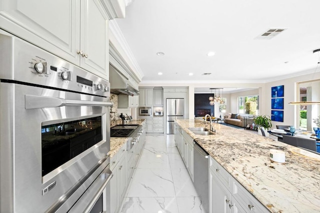 kitchen with light stone counters, marble finish floor, appliances with stainless steel finishes, and a sink