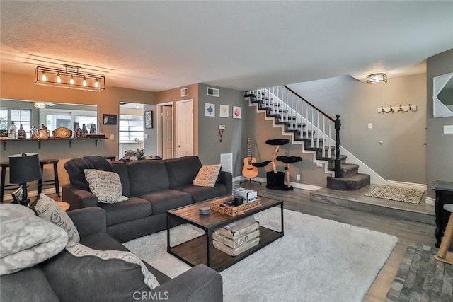 415 Jeremiah Dr Unit B, Simi Valley, CA 93065 - living room featuring wood finished floors, baseboards, visible vents, and stairs