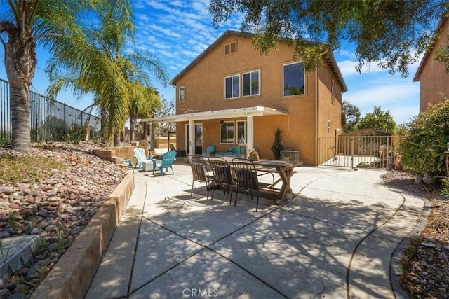 31598 Summerfield Ln, Murrieta, CA 92563 - rear view of property with stucco siding, fence, a patio area, and outdoor dining space