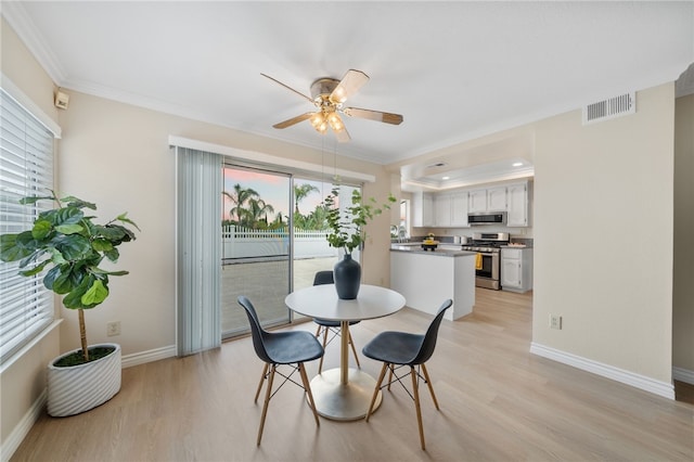 dining space with ceiling fan, visible vents, baseboards, ornamental molding, and light wood-style flooring